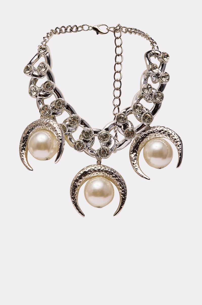 The WESTERN VIBEZ NECKLACE is a silver statement piece featuring three crescent moons with large pearl centers, round rhinestone accents, and a secure chain clasp.