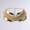 Introducing the TOO FAMOUS CHOKER NECKLACE: a gold necklace featuring a contemporary, sculptural design with smooth, reflective metal elements interwoven with multiple strands of delicate chains. This eye-catching piece includes an adjustable chain clasp and is presented against a plain, light gray background.