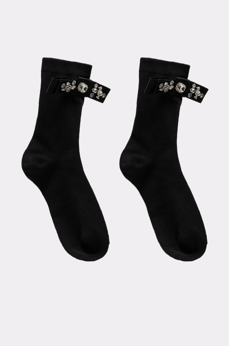 WITH A PUMP EMBELLISHED SOCKS are black crew socks featuring decorative black straps with rhinestone floral and circular patterns, perfect for adding sparkle to your embellished socks collection. 1