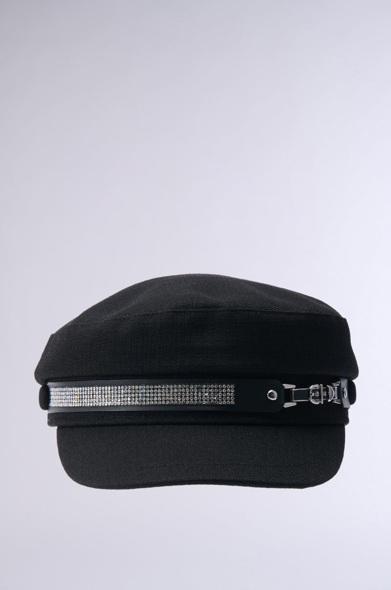 The ITS GIVING BLING BAKER HAT features a chic sailor-style in black, enhanced by a silver rhinestone band across the front, all placed on a simple gray background. 3