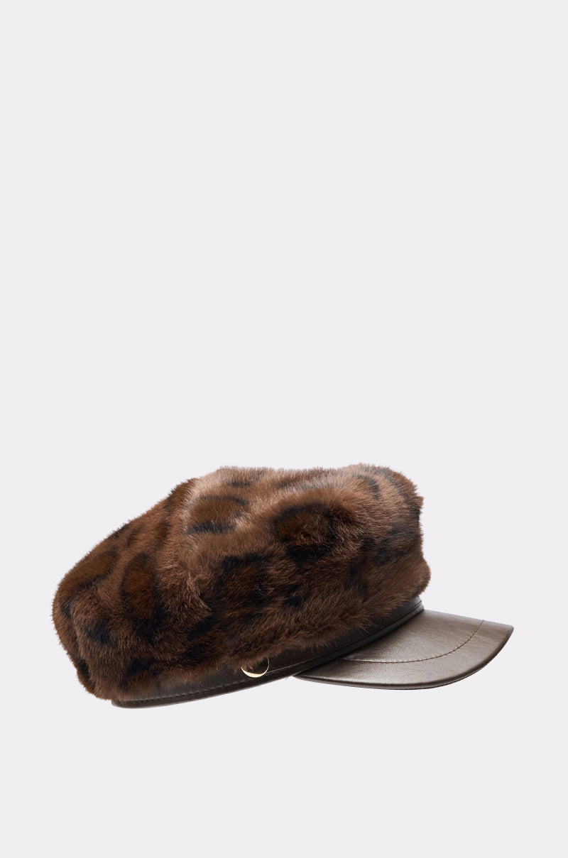 The I AM THE LUXURY FAUX FUR BRIM HAT features a brown and black cheetah print faux fur top with a smooth dark brown leather visor and trim, displayed against a plain light background. 3