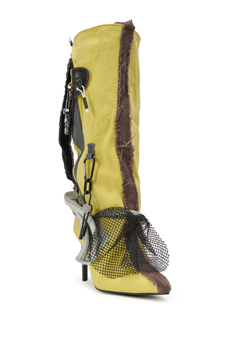 The AKIRA GOLD COALESCE SPORTY MIXED MATERIAL STILETTO BOOT features high-heeled yellow knee-high design with brown frayed edges, a black mesh bow on the toe, silver chain and keyring details, plus a pointed toe for avant-garde flair. 3