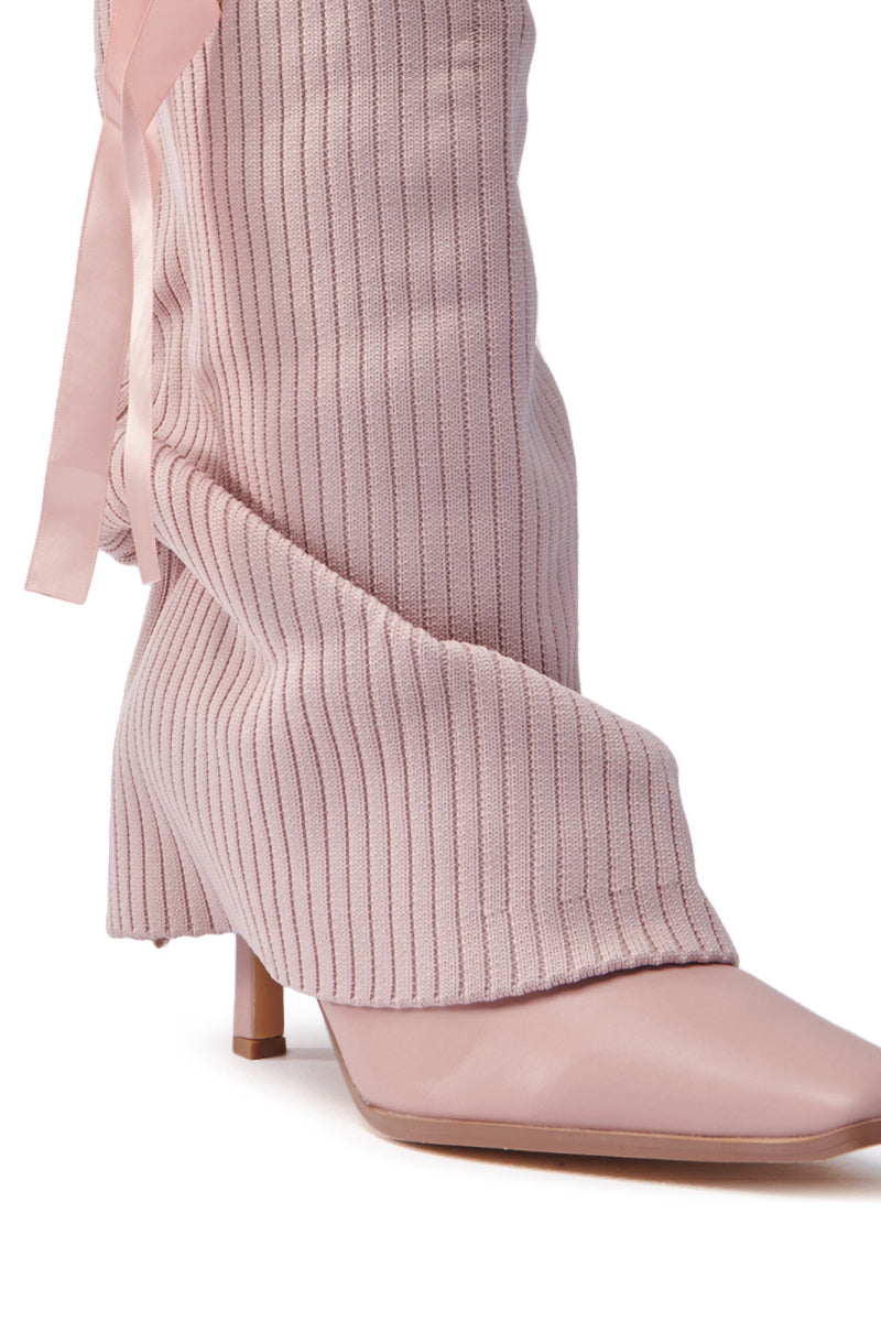 Close-up of the CODEWORDS PINK BOW STILETTO FOLD OVER BOOT, showcasing a vegan leather design with a ribbed texture and pointed toe. This stylish boot features chic ribbon detail along the side, finished with a low, angular heel.