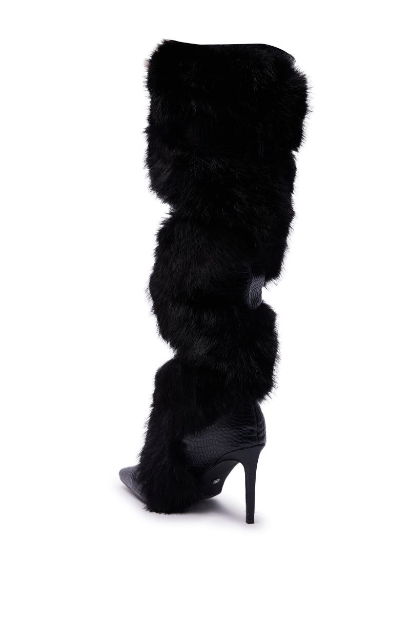 The AZALEA WANG CONRADDE Black Mixed Material Fur and Snake Stiletto Boot is a tall, knee-high black boot with faux fur and snake details, a pointed toe, and high stiletto heel, shown on a white background.