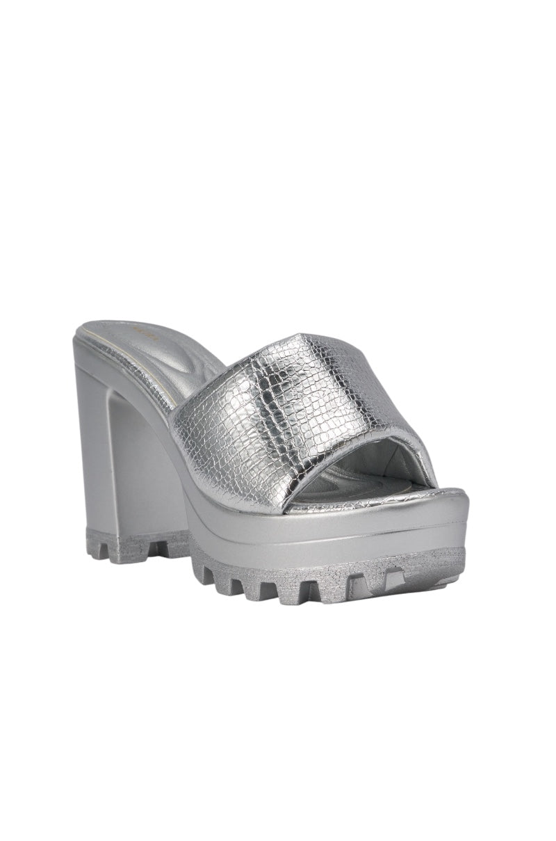The AKIRA COOLCAT SILVER CROC BLOCK HEEL MULE SANDAL features metallic silver crocodile-pattern faux leather straps and a chunky block heel. 4