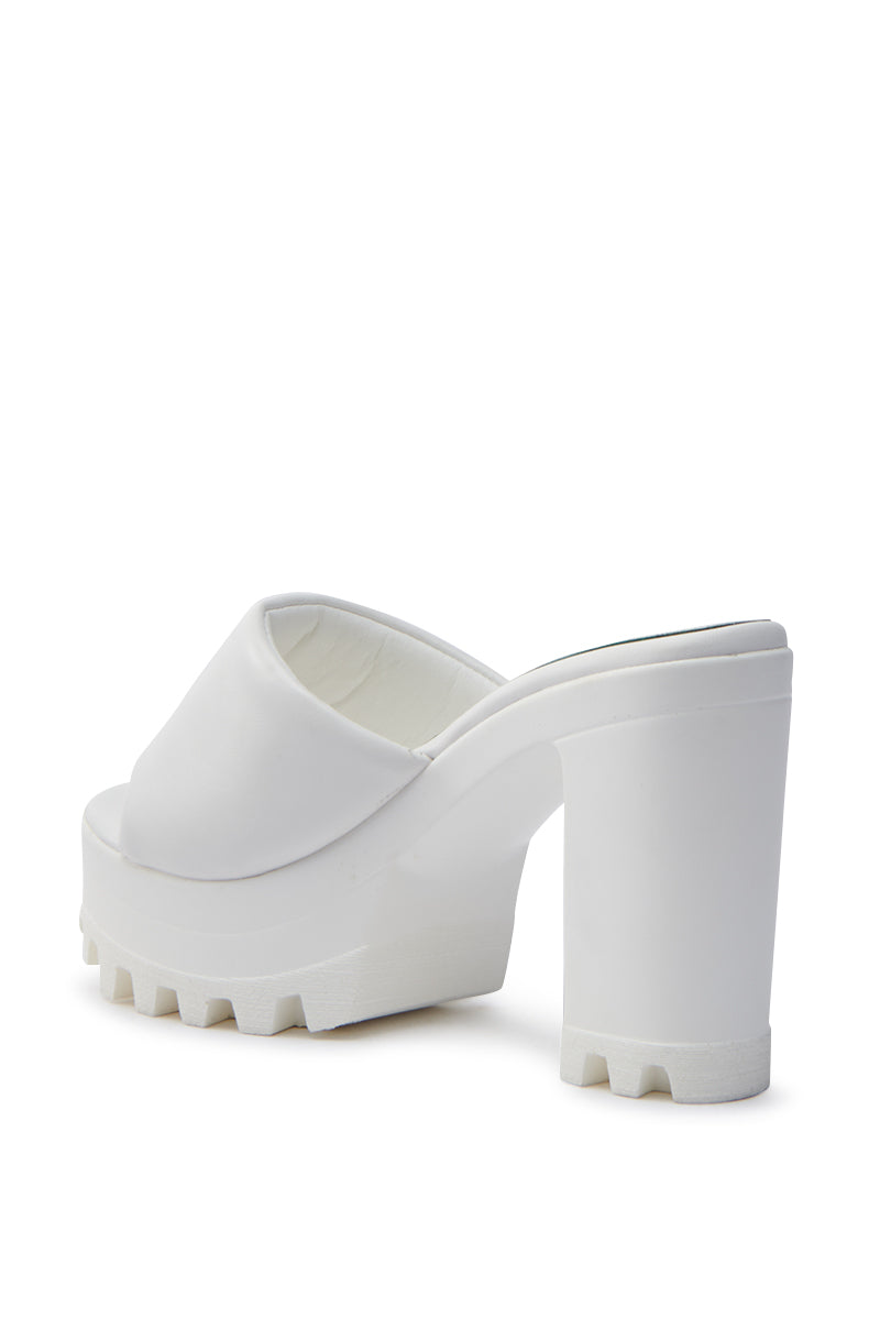 The AKIRA COOL CAT WHITE PUFFY PLATFORM SANDAL, a high-heeled platform mule with an open toe, chunky heel, treaded sole, and comfort cushion insole, is displayed against a plain white background.