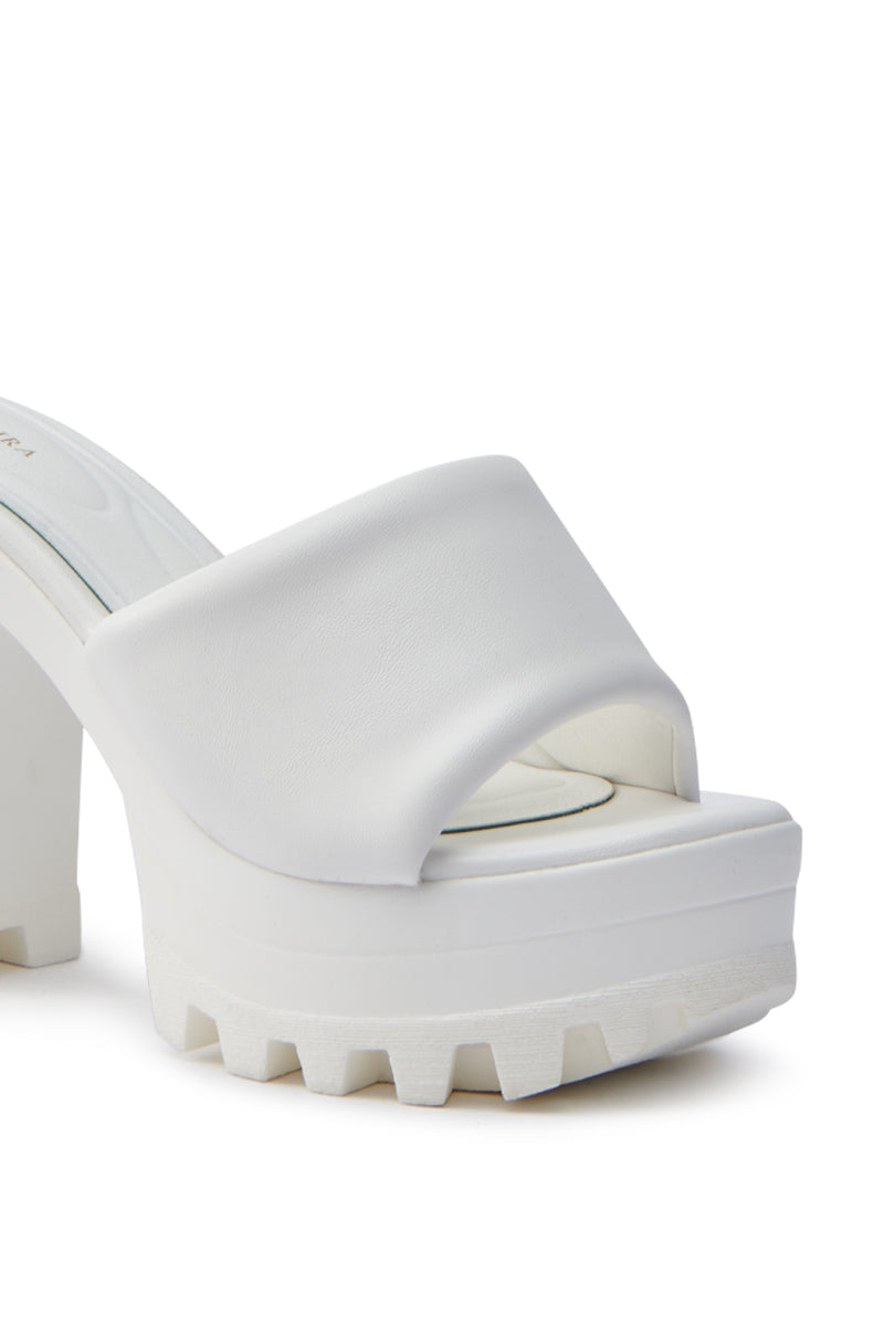 The AKIRA COOL CAT WHITE PUFFY PLATFORM SANDAL is a white chunky slide with a lug sole, open toe, and wide strap. It boasts a thick high heel for added height and style, plus a Comfort Cushion insole for all-day comfort.