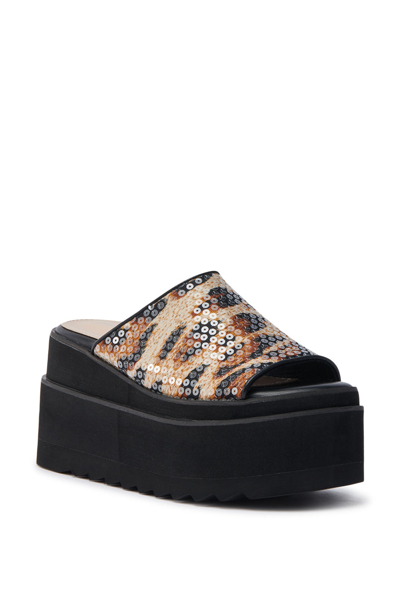 The AZALEA WANG CORLISS LEOPARD FLATFORM SANDAL features a thick black sole, wide open-toe upper with shiny sequins and leopard print, plus a cushioned faux leather insole for comfort.