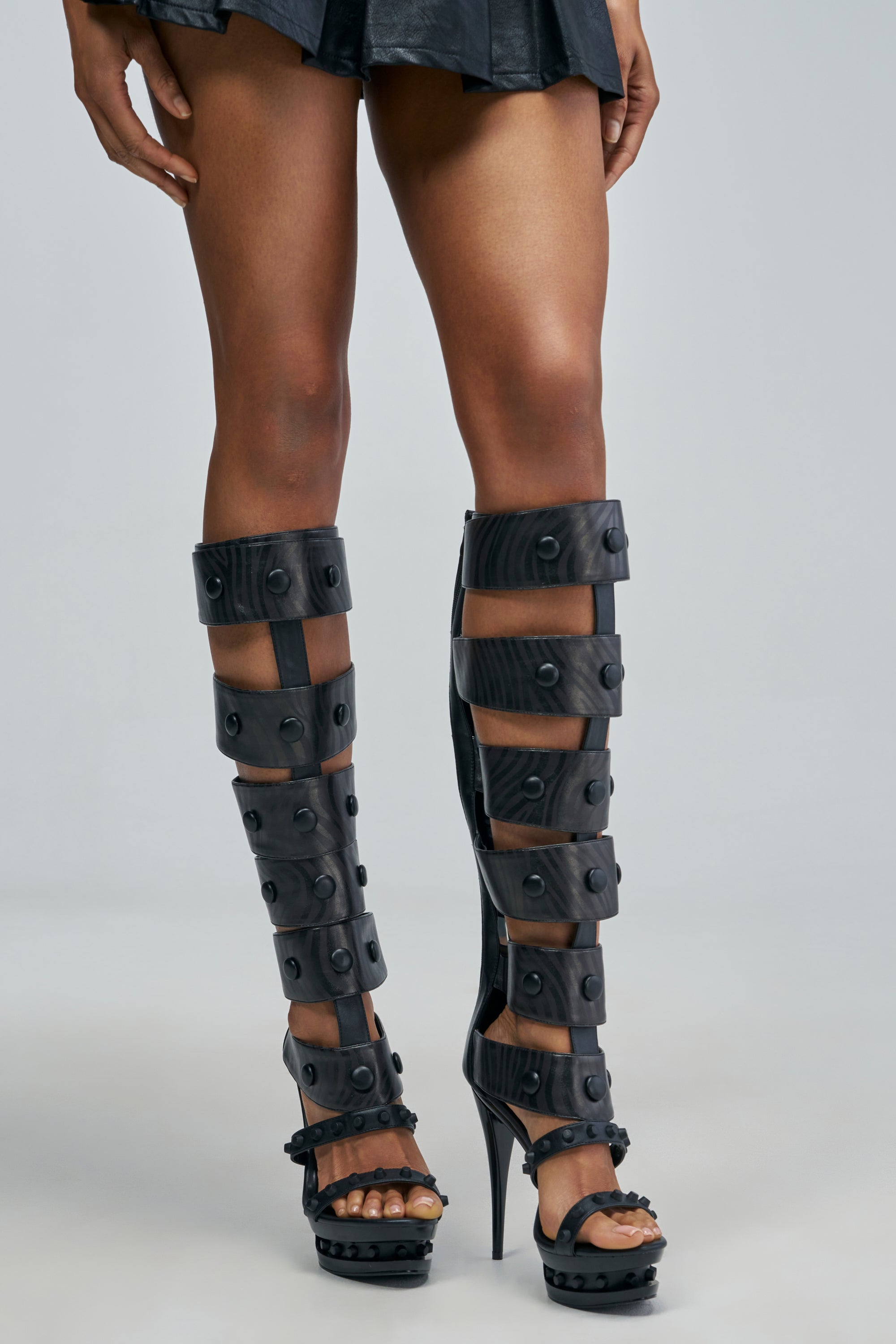 AZALEA WANG COURAGE BLACK OPEN TOE STILETTO BOOT in black faux leather, featuring a knee-high silhouette with multiple buckled straps accented by studs.
