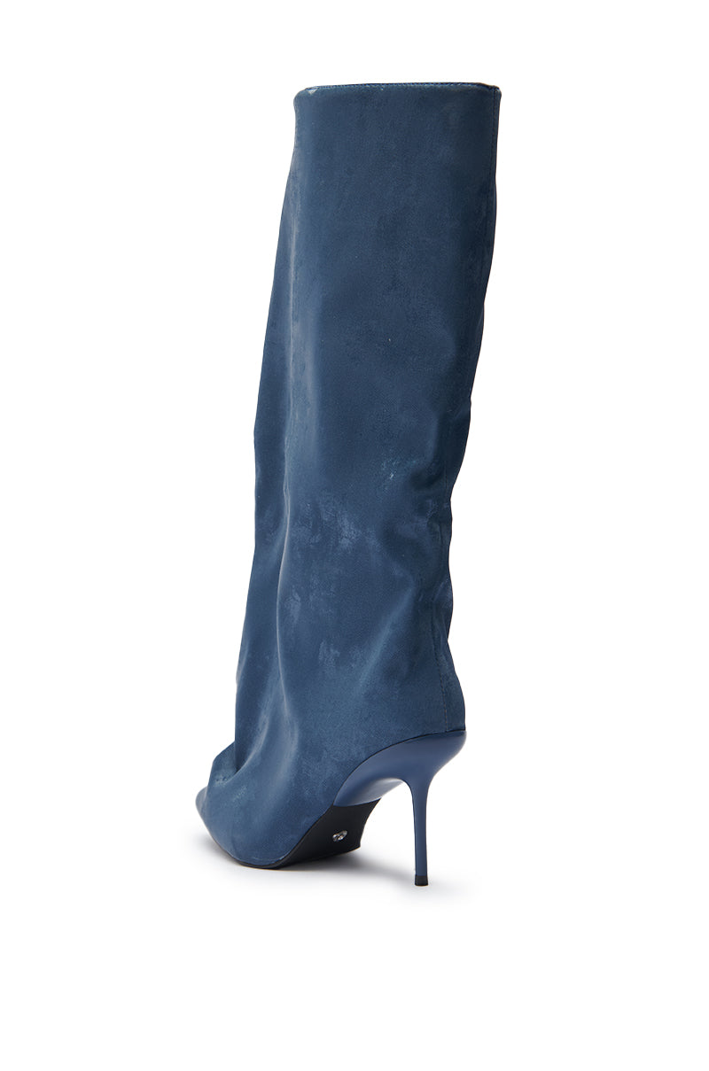 The AZALEA WANG COUTURE CRAZY BLUE LUXE SHINE LOOK BOOT is a blue patent leather, knee-high slouchy boot with a pointed toe and thin stiletto heel, displayed angled against a white background.