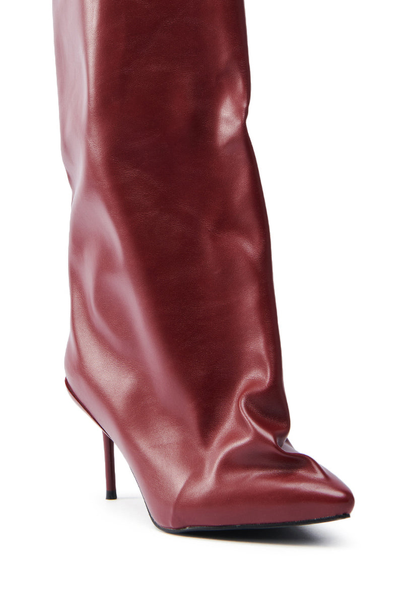 A close-up of the AZALEA WANG COUTURECRAZY BURGUNDY BOOT reveals a pointed toe, high stiletto heel, and slightly wrinkled burgundy faux leather.