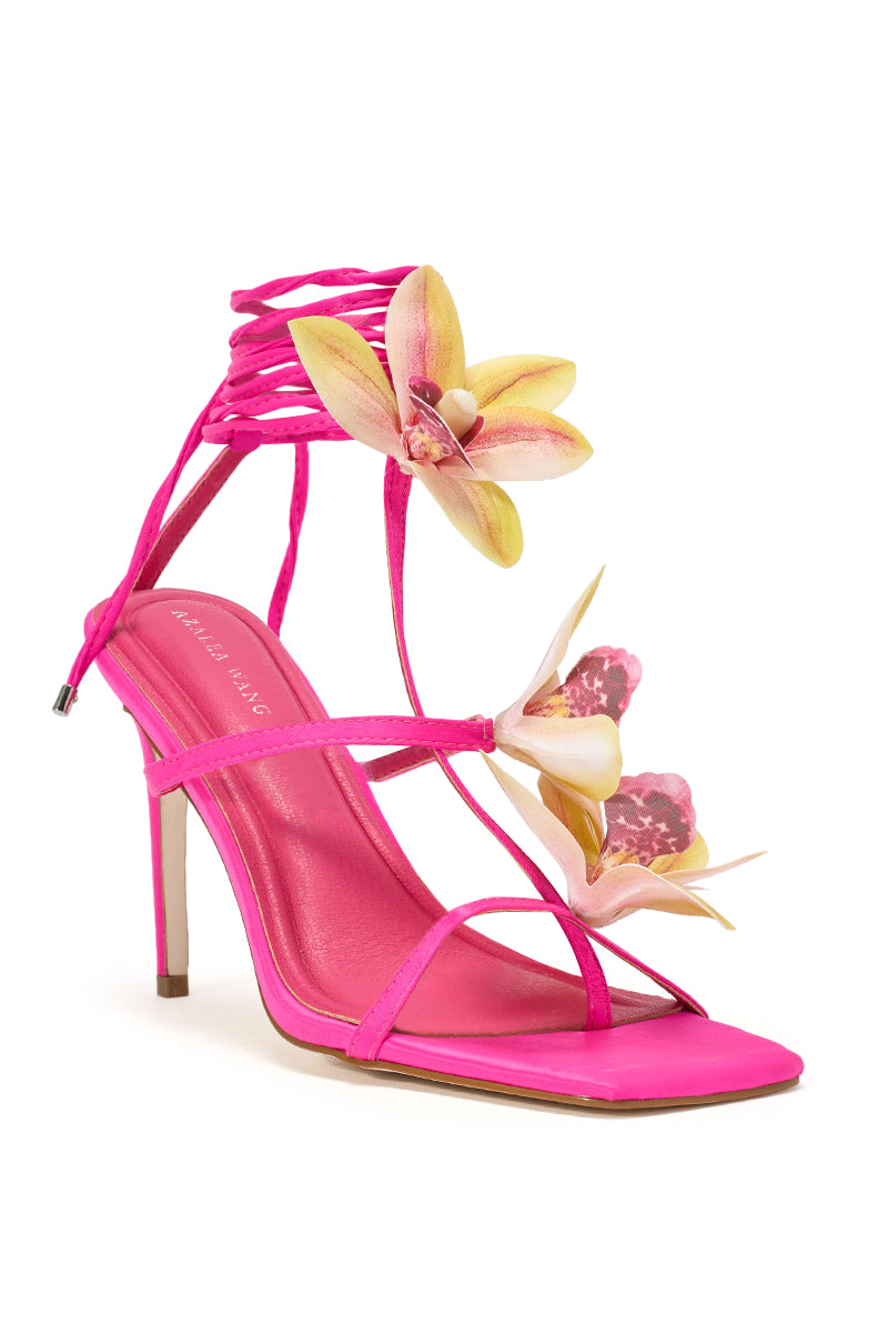 The AZALEA WANG CRESCENDO FUCHSIA STILETTO SANDAL features bright pink thin straps, a lace-up ankle, and eye-catching yellow and pink artificial orchid flowers on the front and side—perfect tropical-inspired floral heels. 5