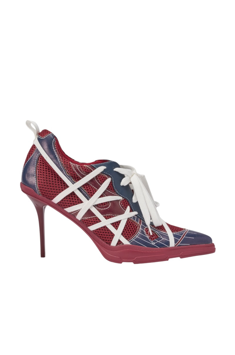 The AZALEA WANG CROSS WALK BURGUNDY STILETTO SNEAKER HEEL features a pointed toe, red mesh base, navy and red leather overlays, white crisscross straps, and white laces. The slender stiletto heel matches the burgundy detailing. 3