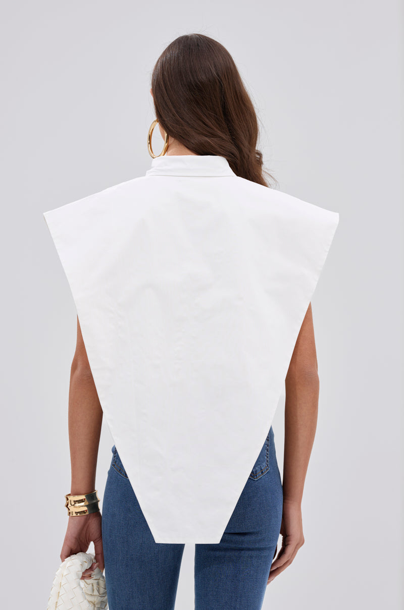 A woman with long brown hair is seen from behind wearing the ALWAYS GIVING BUTTON DOWN POPLIN BLOUSE—a sleeveless white geometric top with pointed shoulders—over blue jeans, styled with gold hoop earrings, bracelets, and a white woven clutch. 2