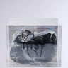 A pair of black bra inserts is visible through clear plastic packaging labeled "ULTIMATE PUSHUP NIPPIE CUTLETS IN BLACK," designed to enhance cleavage volume.