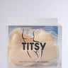 The "ULTIMATE PUSHUP NIPPIE CUTLETS IN NUDE" come in transparent packaging, revealing minimalist beige inserts designed to enhance cleavage and subtle elegance against a neutral background.