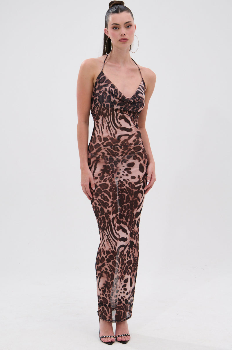 A woman poses against a white background wearing the ON TREND Mesh Midi Dress in Animal Print with spaghetti straps and open-toe heels. Her long hair is styled in a high ponytail, paired with large hoop earrings for a bold look. 3