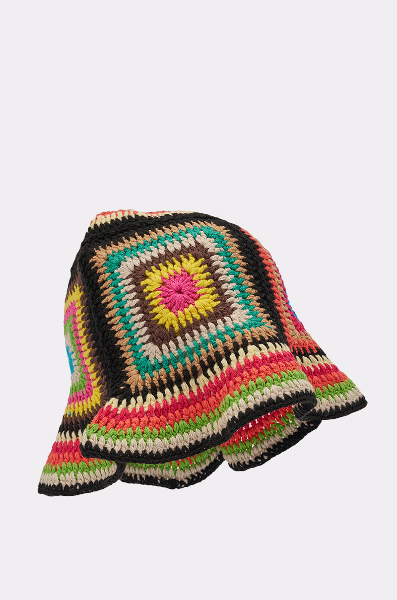 The DND CROCHET BUCKET HAT features a retro granny-square pattern in green, brown, pink, yellow, black, and beige yarn, shown on a plain white background. 4