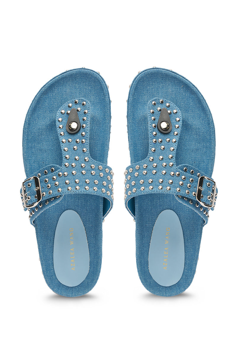 The AZALEA WANG DAISY CHAIN DENIM STUDDED FLAT SANDAL features blue denim, studded accents, a buckle strap, and flat sole, displayed from above on a white background. 3