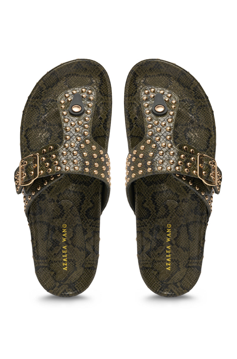The AZALEA WANG DAISY CHAIN GREEN SNAKE STUDDED FLAT SANDAL features dark green faux leather with snake-print, gold studs on the straps, adjustable buckles, and “Azalea Wang” in gold on the footbed. 3