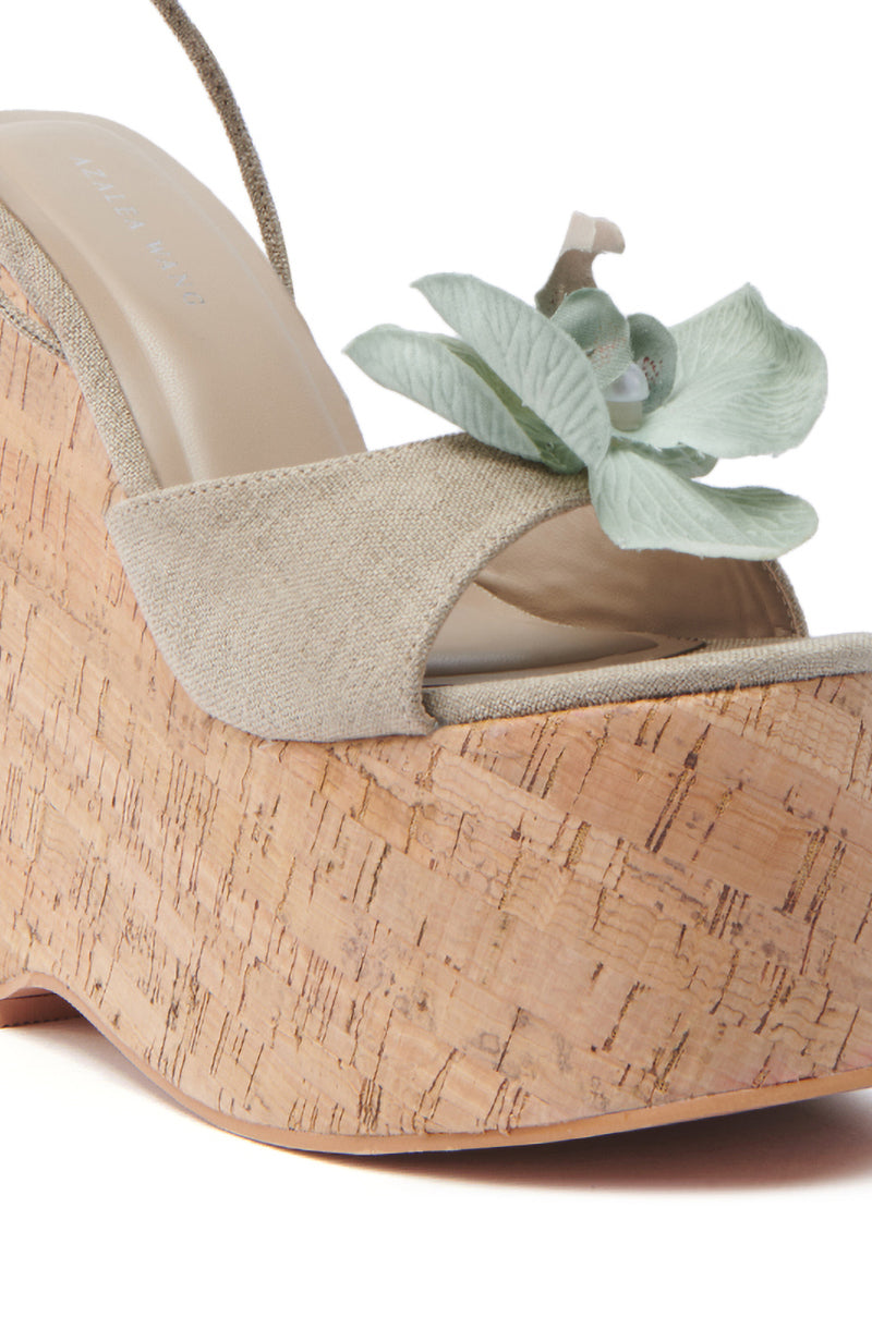 The AZALEA WANG DALEYZA sandal is a beige wedge with a cork heel, open toe, and green floral strap decoration.