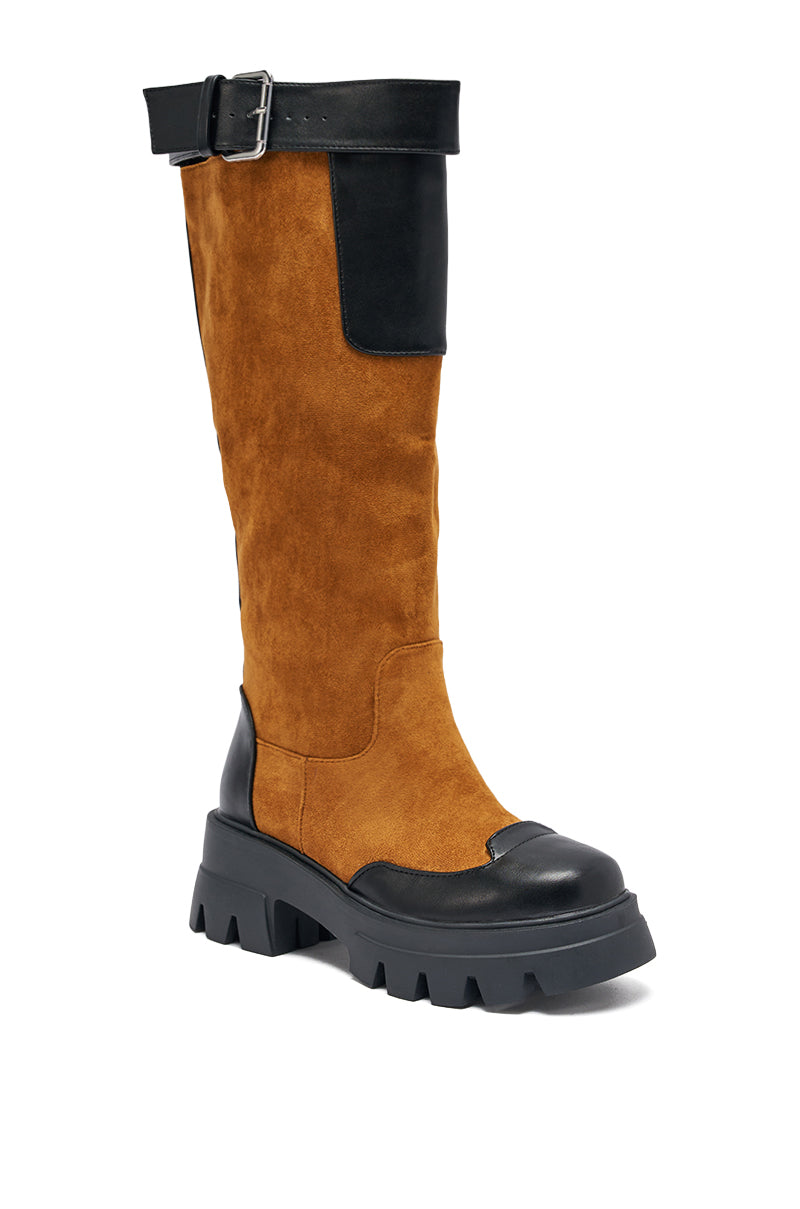 The AZALEA WANG DALILA COLOR BLOCKED FLATFORM BOOT IN COGNAC features a chunky black sole, color blocked flatform design, black leather toe cap and top with buckle, and a rich brown faux suede shaft for a rugged, modern look. 4