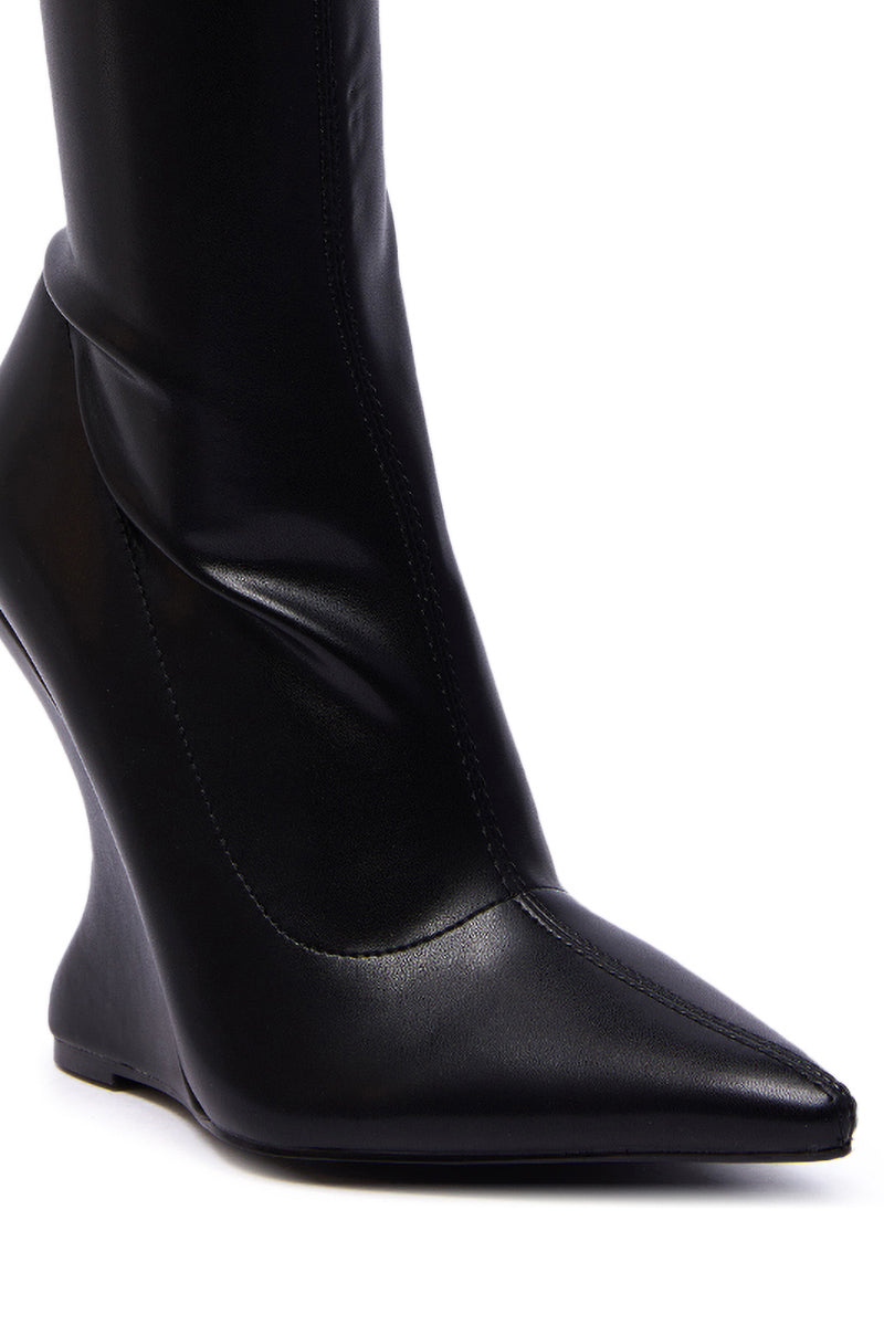 A close-up of the AZALEA WANG DAMAN BLACK PU WEDGE BOOTIE, featuring a pointed toe and unique curved wedge heel in smooth black PU material.