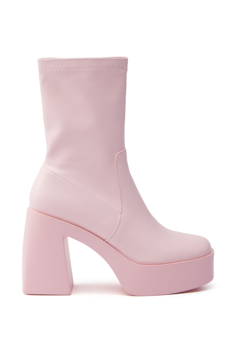 The AZALEA WANG DANIELLE BABY PINK STRETCH PU CHUNKY HEEL BOOTIE features a high block heel, smooth PU upper, sleek design with an ankle-high shaft, and no visible fastenings, elegantly set against a white background.