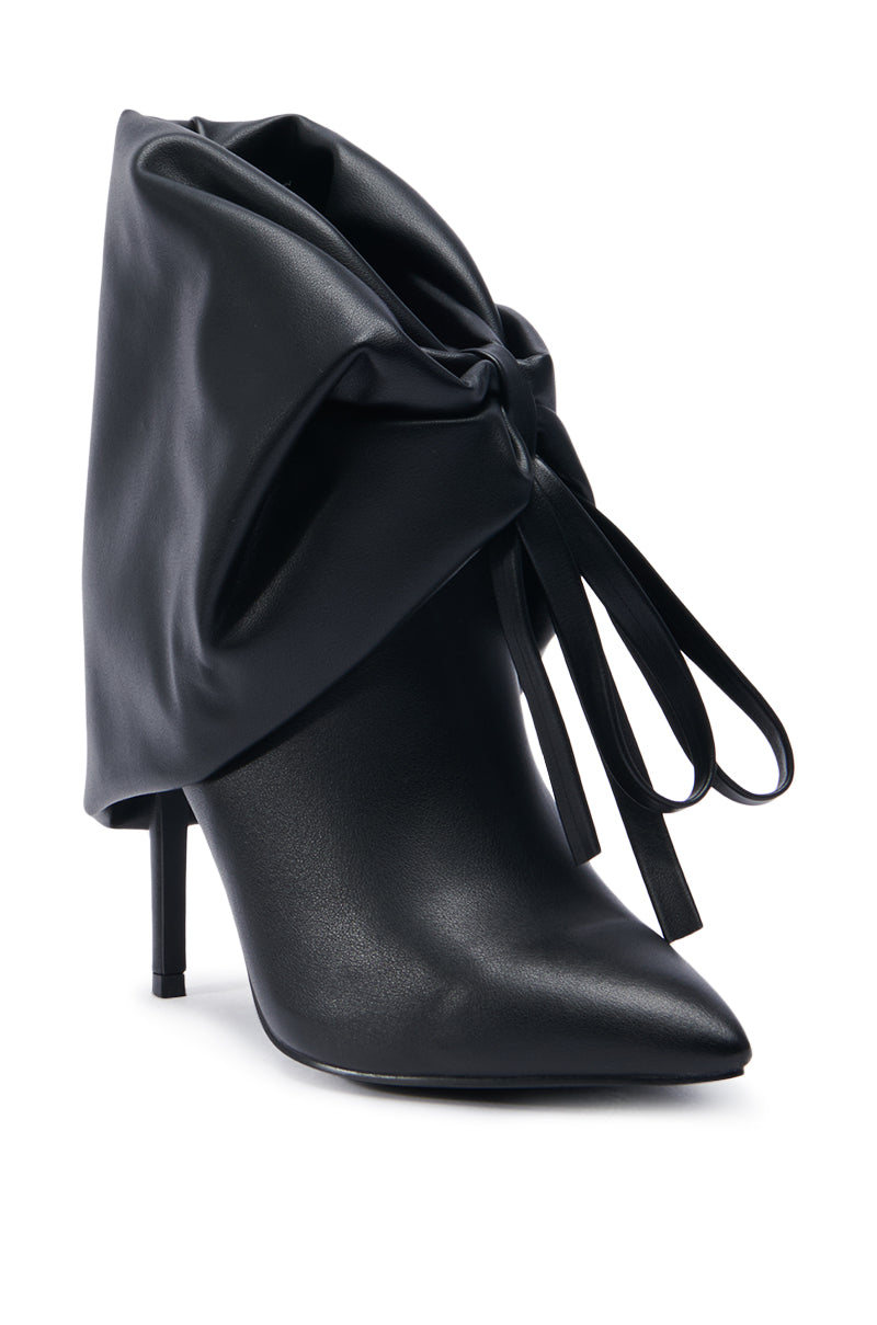 Introducing the AZALEA WANG DARALEY STILETTO BOOTIE: a sleek and elegant black pointed toe high-heeled boot, featuring a distinctive oversized bow detail on the side. Crafted from smooth faux leather, this sophisticated stiletto heel design enhances any outfit with its touch of elegance.