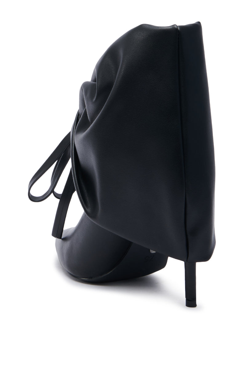 The AZALEA WANG DARALEY STILETTO BOOTIE features a striking black high-heeled design with an oversized drape that elegantly covers the back and side. Its pointed toe perfectly matches the slender stiletto heel, and the smooth, glossy faux leather material accentuates its modern, avant-garde appearance.