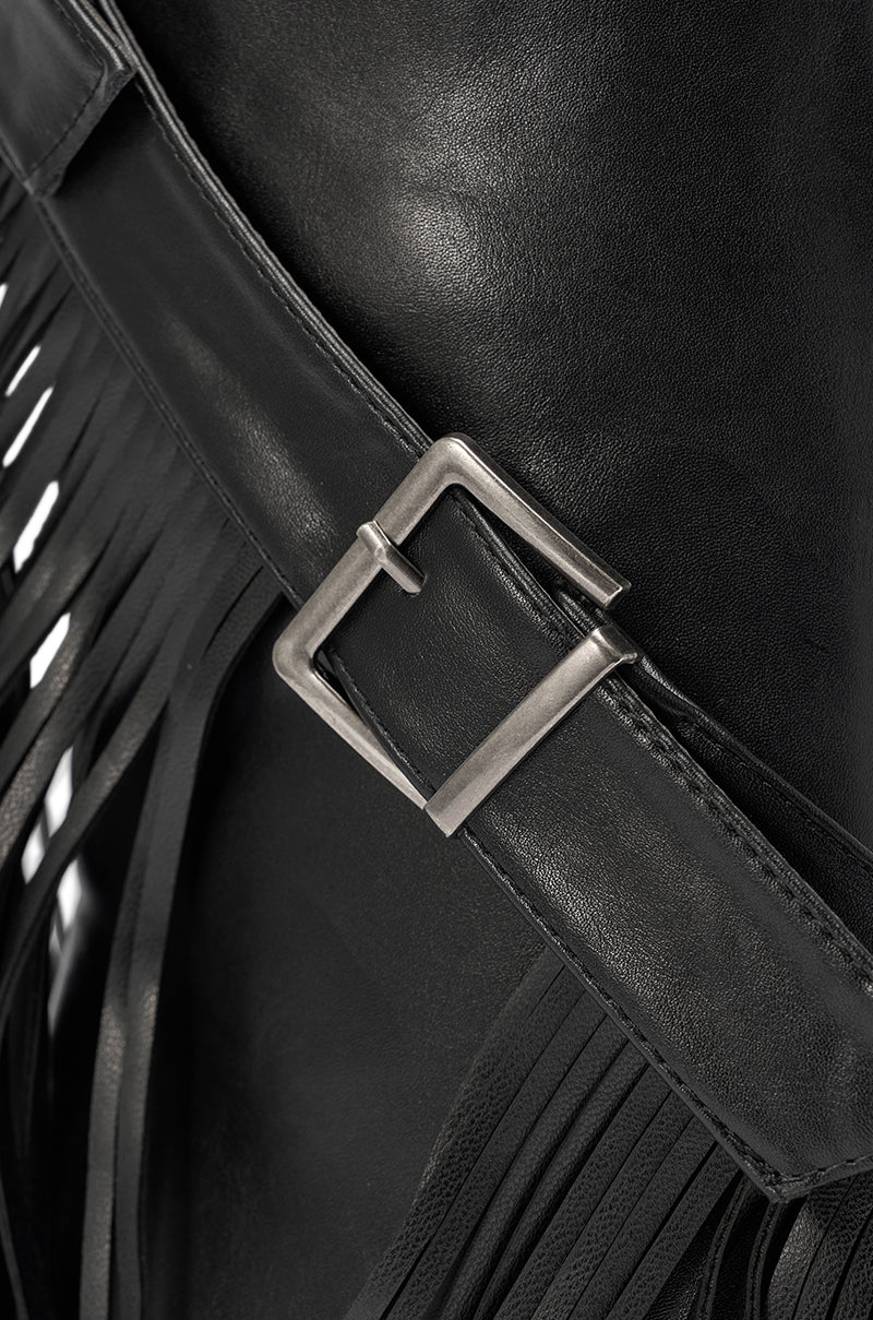 Close-up of the AZALEA WANG DARELLE BLACK FRINGE BOOT featuring a silver metal buckle on a black leather strap with decorative fringe, evoking a western-inspired style. 7
