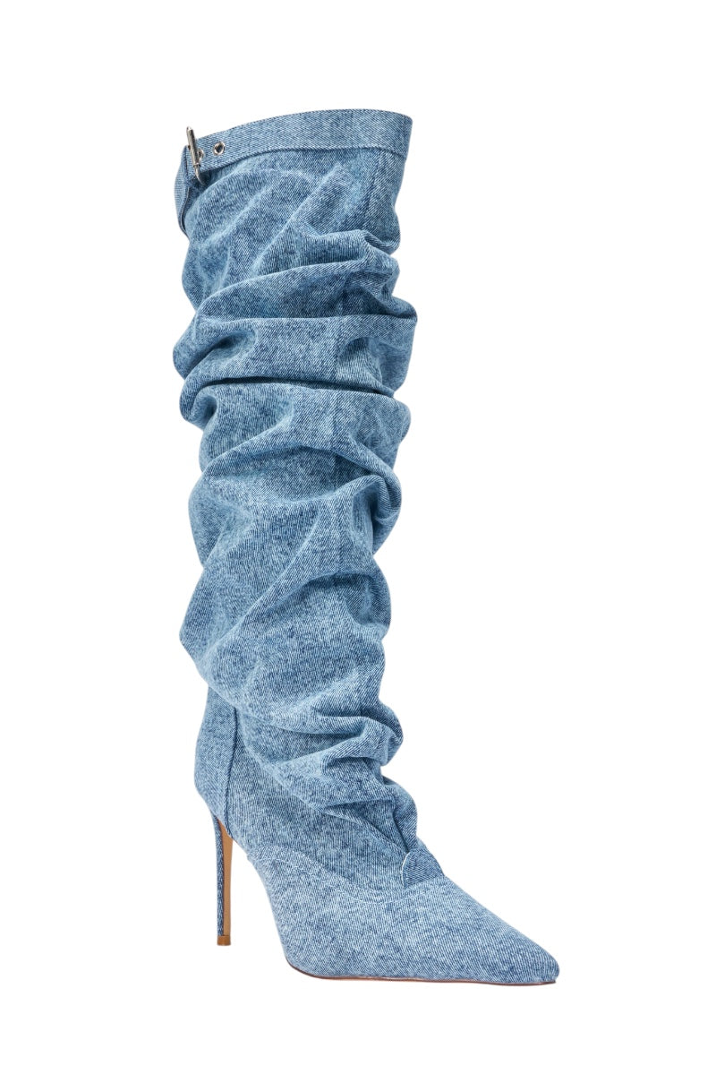 The AZALEA WANG DARIA DENIM STILETTO BOOT is a single high-heeled, pointed-toe slouchy boot in light blue denim with a stiletto heel and a decorative strap detail at the top. 4