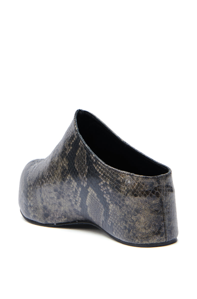 A back angle view of the AZALEA WANG DARWIN CLOG IN BLACK SNAKE, a slip-on faux leather snakeskin shoe with a black and gray pattern, flat sole, and closed toe, displayed against a white background.