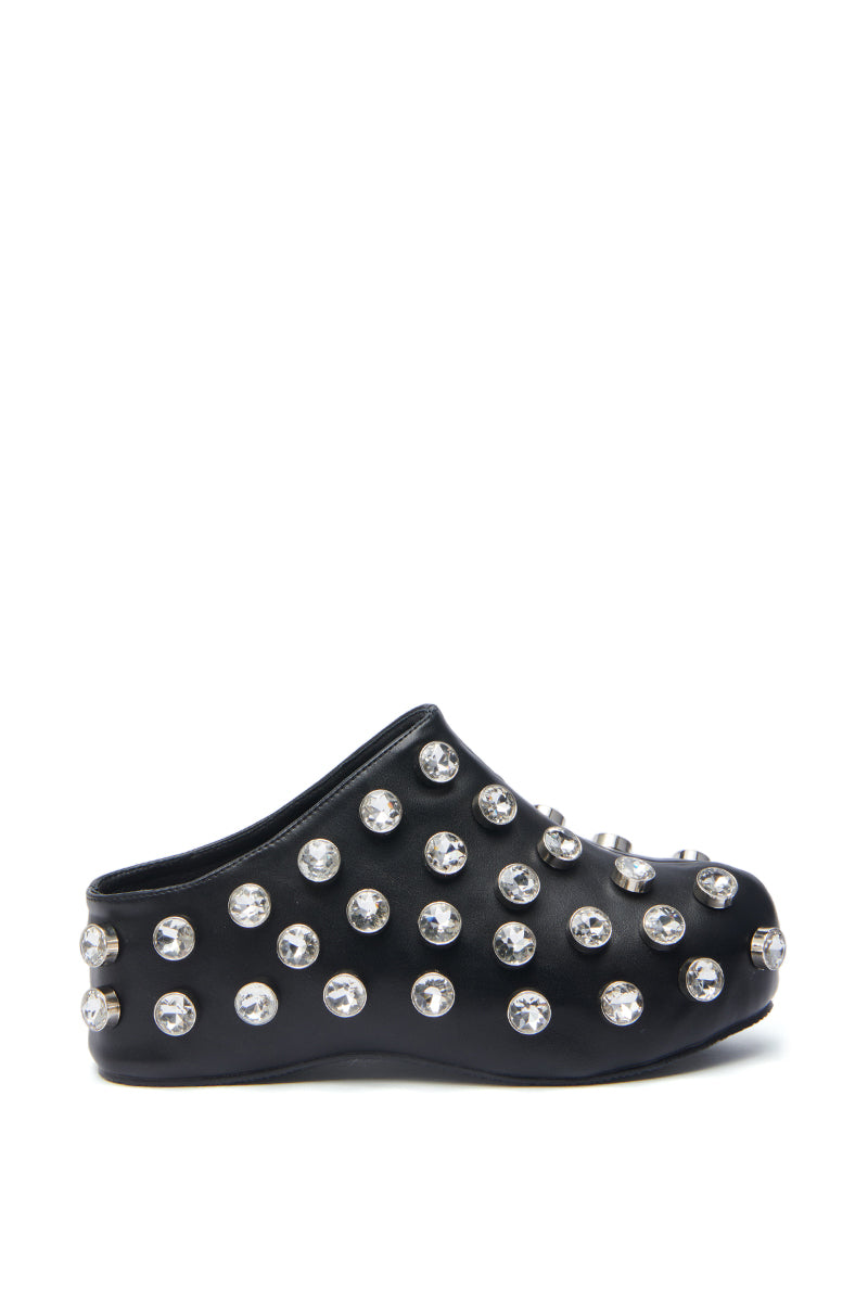 The AZALEA WANG DARWIN STONE RHINESTONE EMBELLISHED CLOG is a black slip-on with a flatform sole, featuring large round silver embellishments across the surface. Set against a plain white background, it makes a bold statement.