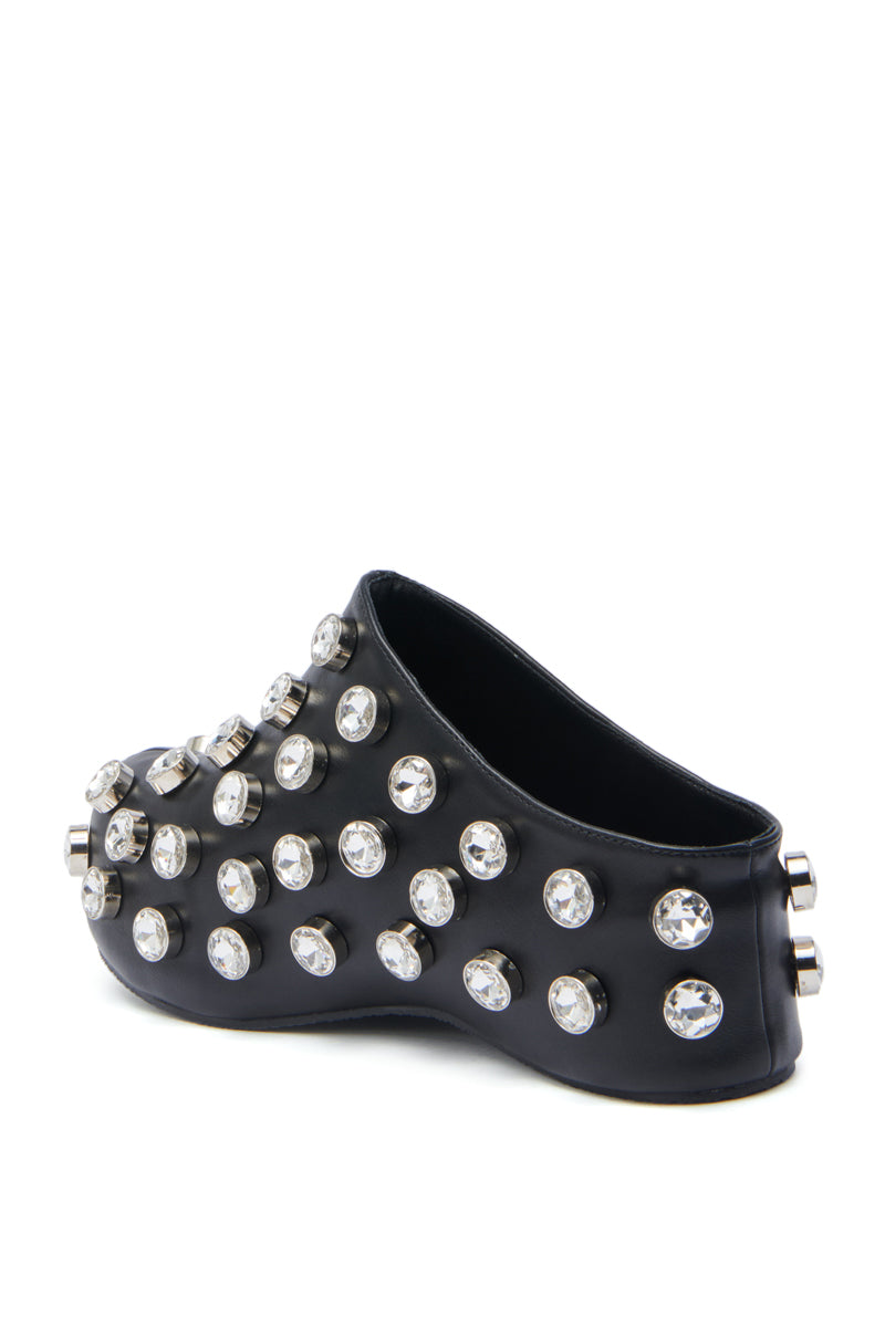The AZALEA WANG DARWIN STONE RHINESTONE EMBELLISHED CLOG is a black slip-on with a sculptural flatform sole, bold silver studs, faceted gem accents, and rhinestone embellishments for an edgy, modern look—no laces needed.