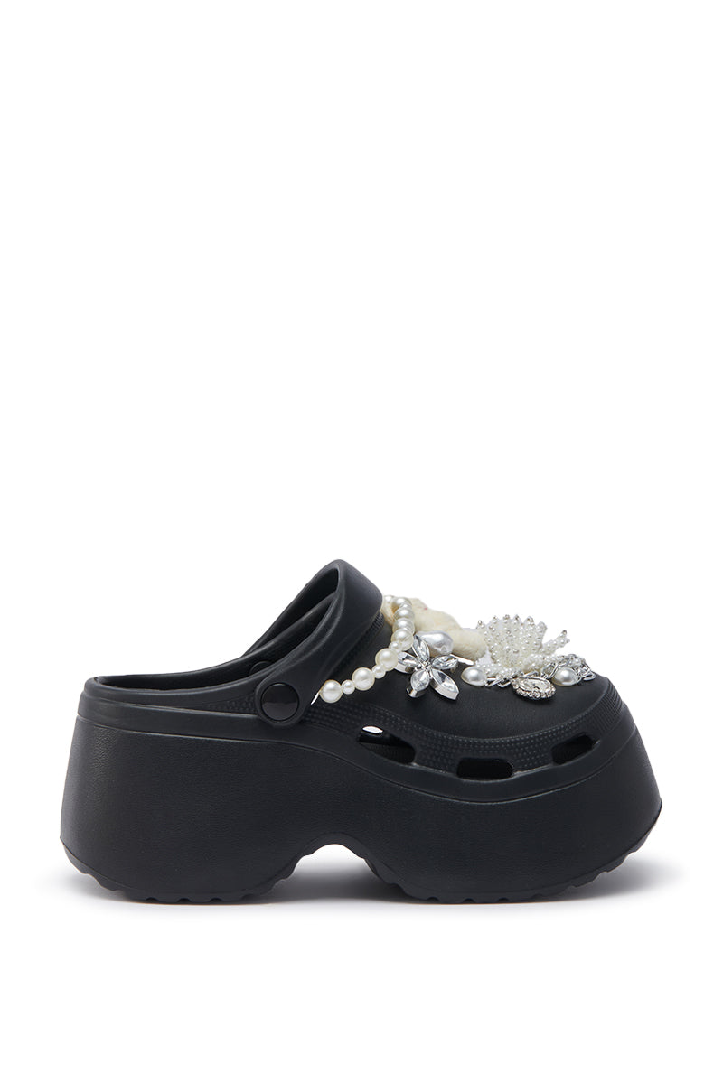 The AZALEA WANG DAVIES BLACK PEARL RHINESTONE FLAT features faux pearls, rhinestones, and floral embellishments on the upper, displayed against a white background.