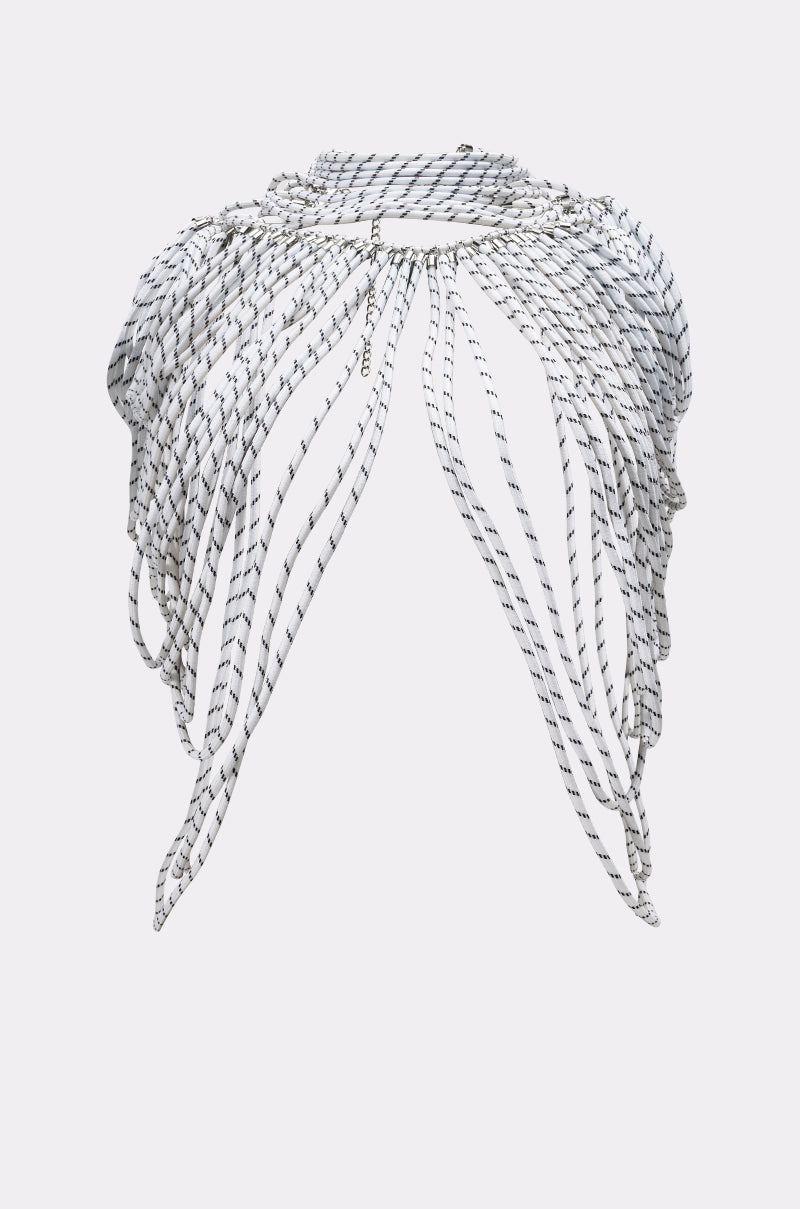 The COURTSIDE BODY NECKLACE features layered strands of black and white beads draped over the shoulders, creating a striking, avant-garde jewelry piece with contemporary necklace appeal. 4