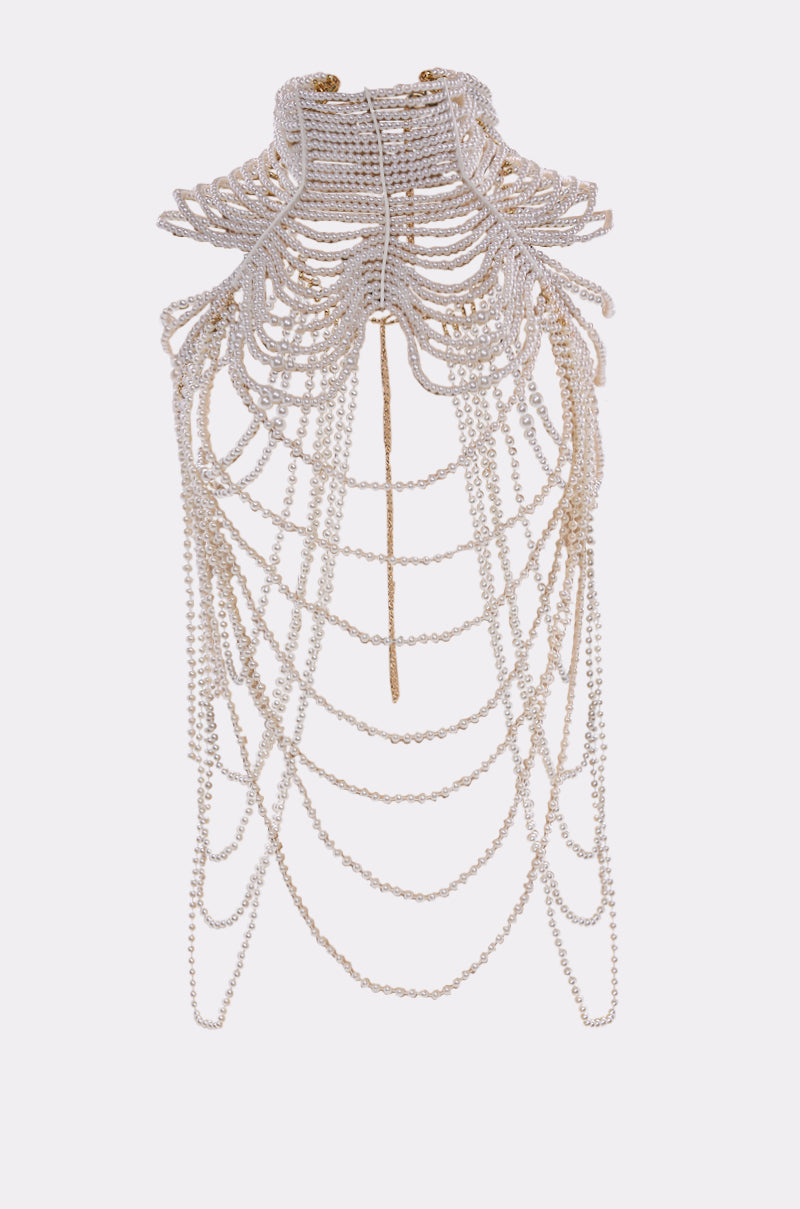 The FEELIN DEMURE BODY CHAIN is an ornate choker featuring multiple layers of small white faux pearls with cascading strands in intricate patterns, creating a dramatic statement design against a plain background. 3
