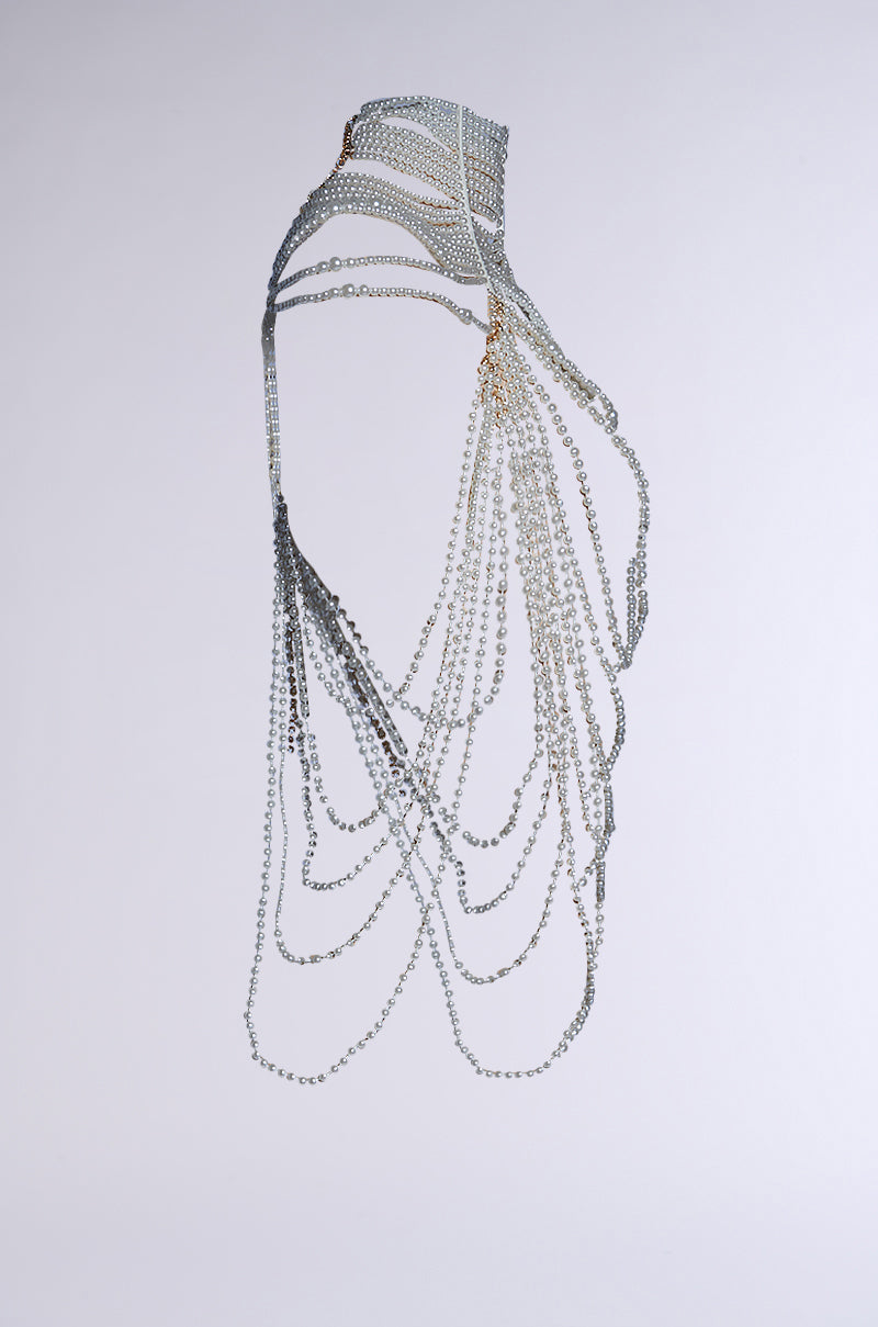 The FEELIN DEMURE BODY CHAIN is a wearable art piece with an adjustable clasp and many silver chains draping elegantly in a choker silhouette, creating cascading effects with intricate, layered patterns on a plain background. 11