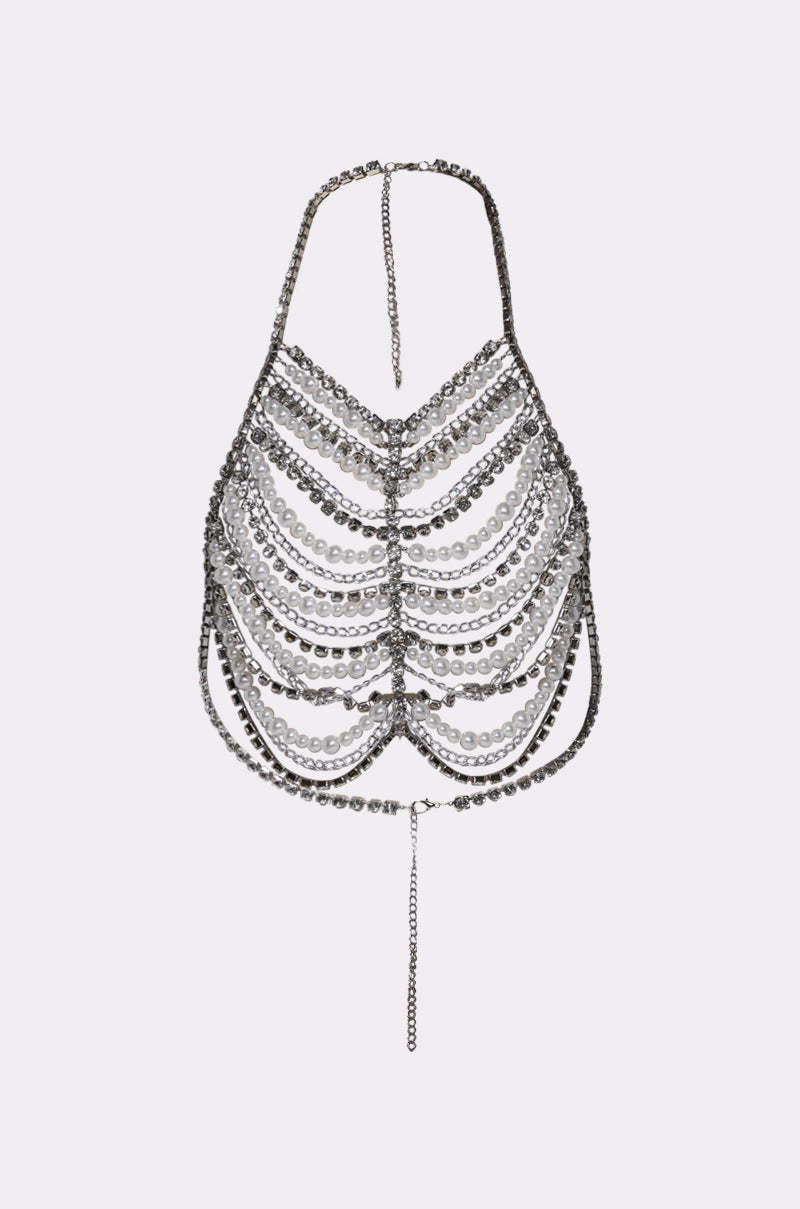 The EVA PEARL AND RHINESTONE BODY CHAIN is a metallic halter-style crop top featuring cascading silver links, rhinestones, a thin neck strap, and a dangling chain detail at the bottom center.