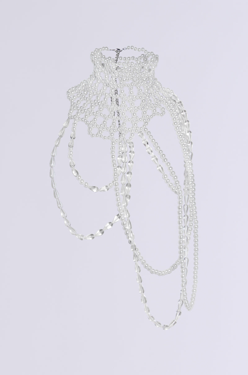 The ELEGANCE IS ME STATEMENT NECKLACE features an intricate, multi-layered design with pearl embellishments and cascading strands of varying lengths, creating a delicate and ornate choker design against a plain white background. 3