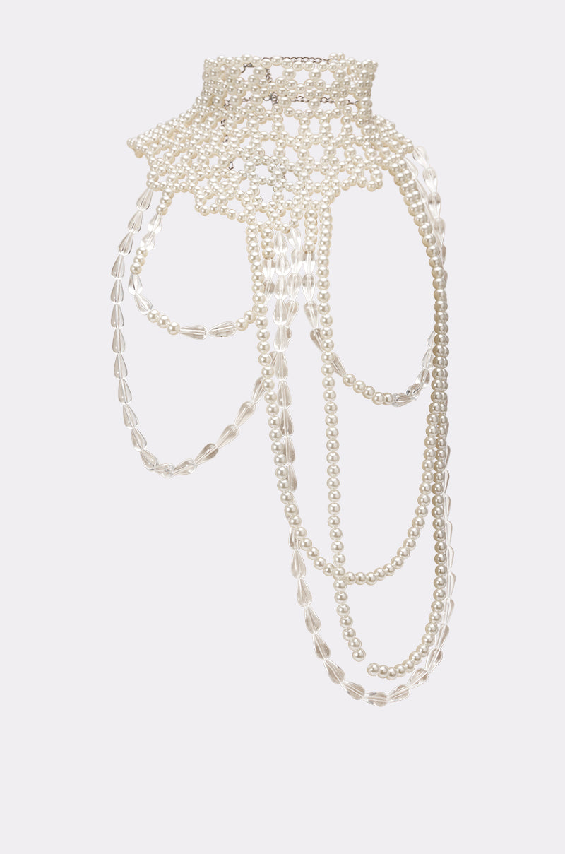 The ELEGANCE IS ME STATEMENT NECKLACE is a choker featuring a lace-like design with small white pearls and clear beads, draping elegantly for a refined, decorative look. 4