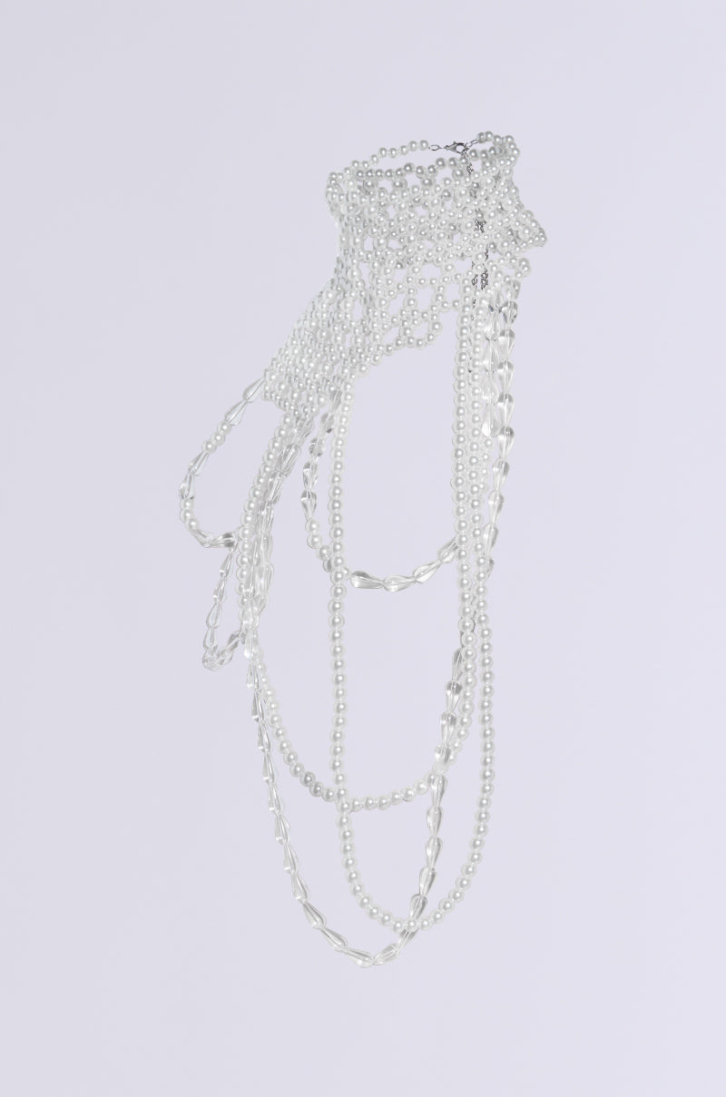 The *ELEGANCE IS ME STATEMENT NECKLACE* collection, showcasing a range of silver necklaces with eye-catching translucent teardrop accents and cascading chain designs, is beautifully displayed against a plain white background. 8