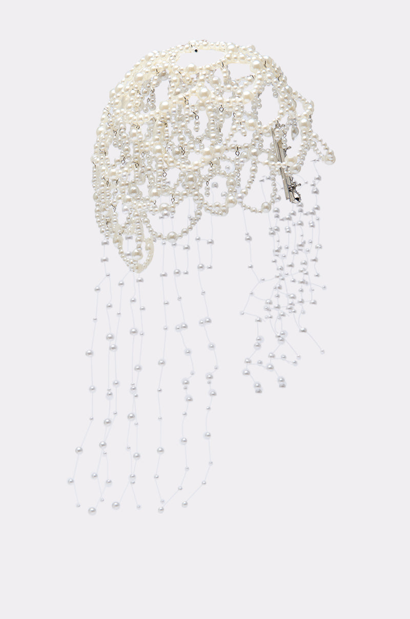 The PEARL LOVE HEADPIECE showcases multiple strands of small white pearls and cascading pearl strings, finished with a metallic hair clip on one side, beautifully displayed against a plain light background.