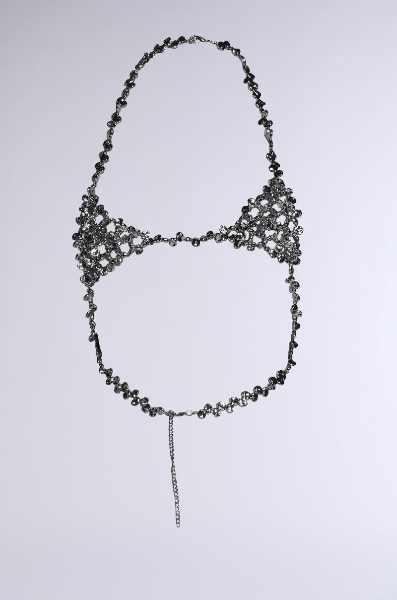 The KEL BODY CHAIN features a delicate bikini top made of interwoven metal rings and hammered silver beads. It forms a net-like pattern against a plain background with a halter-style design and a thin chain draping from the center front. 6