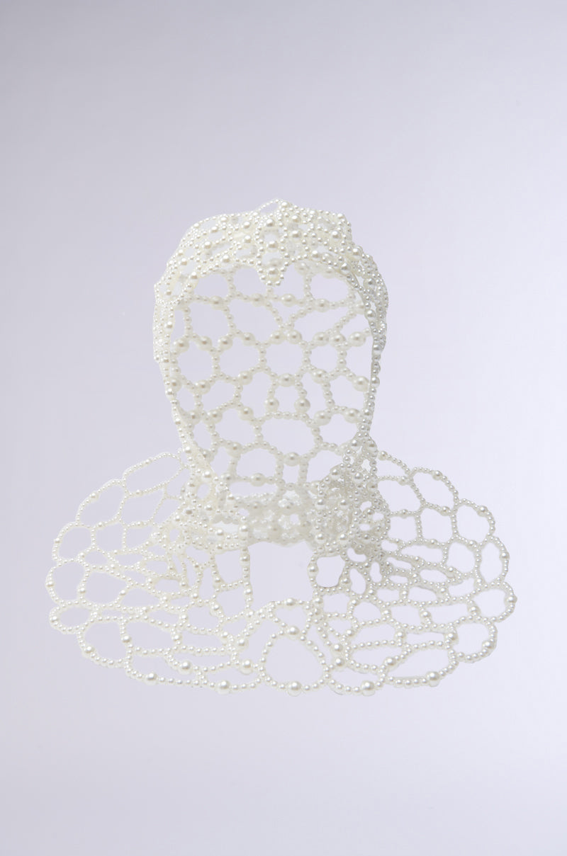 The ELEGANT VIBES PEARL HEADPIECE features a sculptural head and shoulders form crafted from an open lattice of white pearls, outlining a human bust and creating an elegant look against a light background.