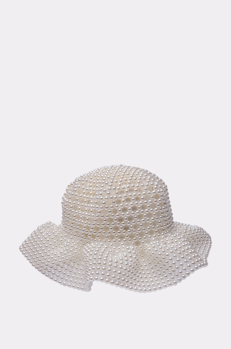 The PEARL DREAMS BUCKET HAT features a wide brim and is adorned with evenly spaced decorative pearls, displayed against a plain light background. 3