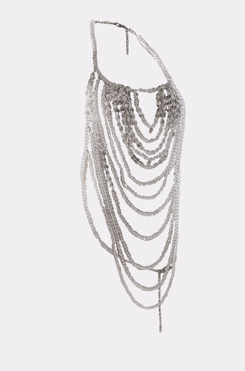 The CLEAR TO ME BODY CHAIN features a silver harness with multiple draped chains of different lengths that layer and cascade over the shoulder and across the torso. 3