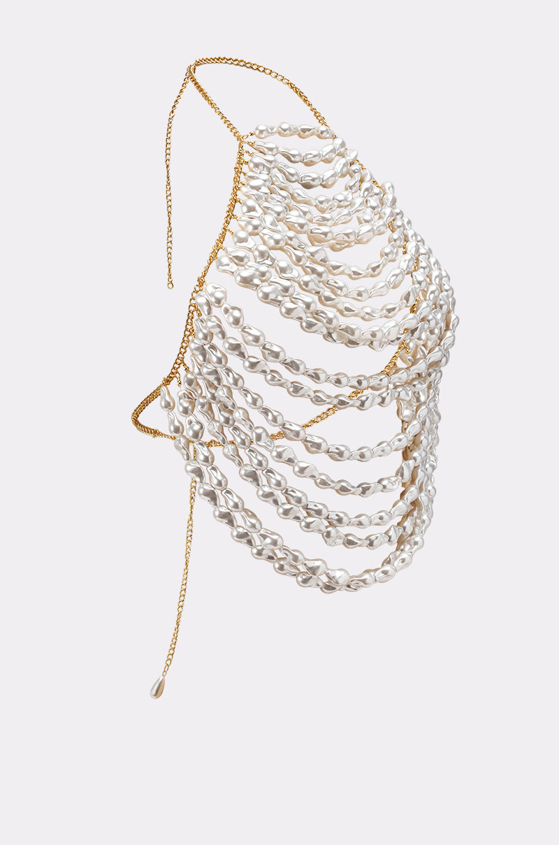 The SHELL YEAH BODY CHAIN is a statement necklace with multiple cascading white pearl strands on a delicate gold chain, showcased against a light grey background. 3
