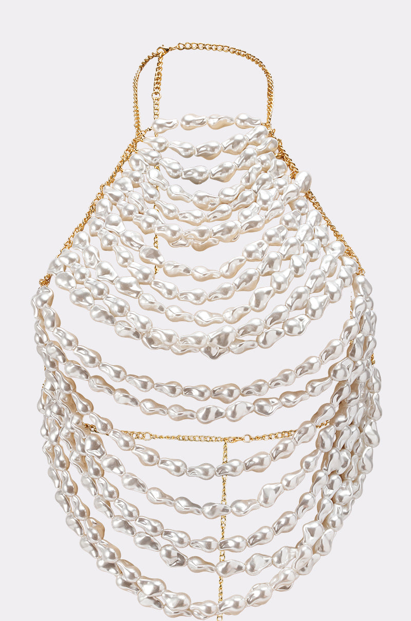 The SHELL YEAH BODY CHAIN features cascading strands of irregular white pearls in wide horizontal layers, creating a striking statement piece that drapes elegantly over the upper body. 4